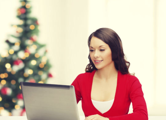 smiling woman in red clothes with laptop computer