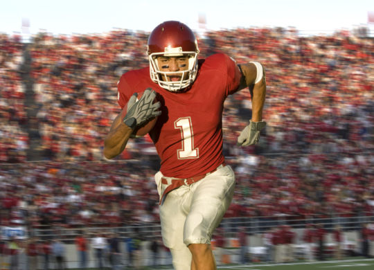 Football Running Back Running Down the Field