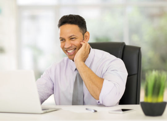 middle aged businessman working on laptop