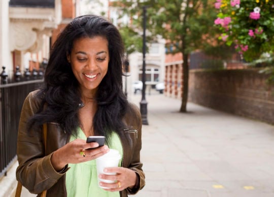 beautiful african american woman checking her messages.