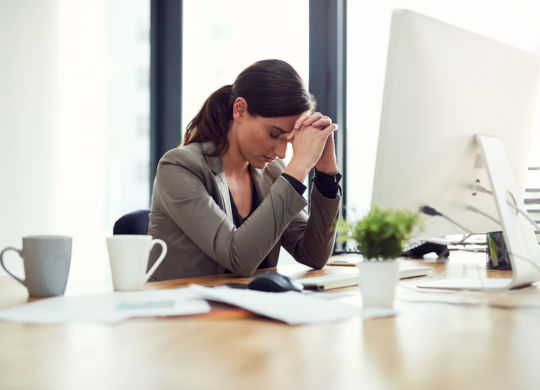 Cropped shot of a young businesswoman looking stressed out while working in an office